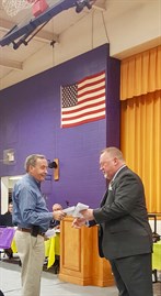Dicky Harris , Chief Of Kenbridge Fire Department , Accepts A Check From Rob Guidry